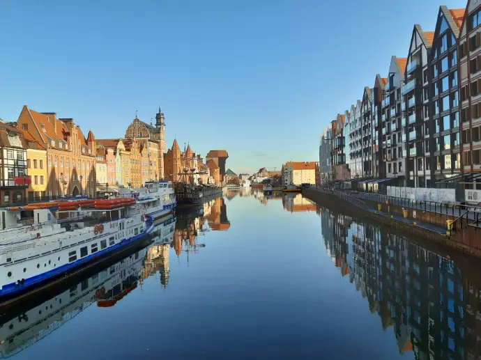 boats on body of water near buildings during daytime